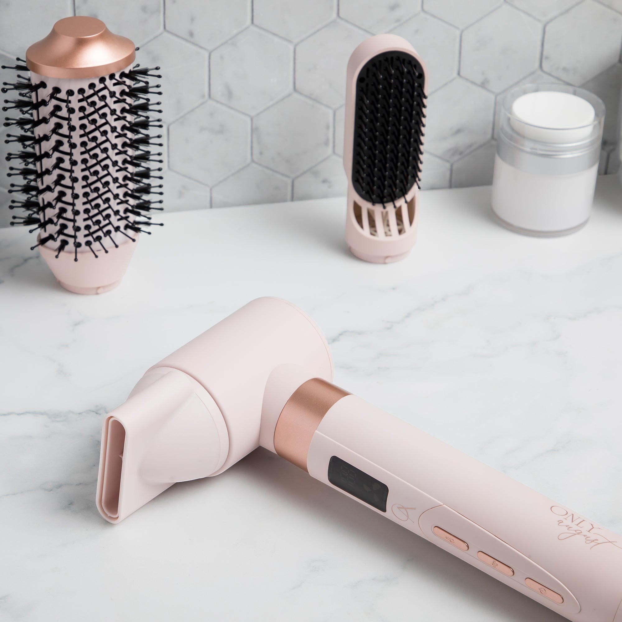 Only August 8-in-1 multi styler in pale pink with rose gold accents. Includes round brush, concentrator, and smoothing brush attachments.